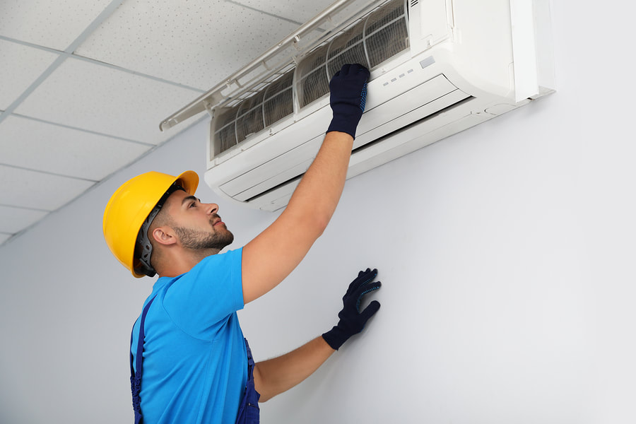 male worker installing the air conditioner