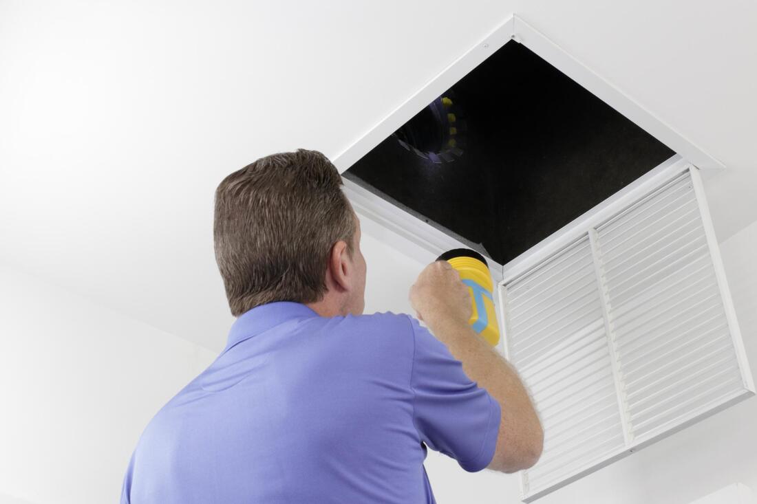 man cleaning the air duct